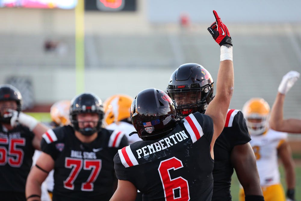 Redshirt sophomore running back Vaughn Pemberton celebrates with his teammates after scoring a touchdown against Kent State Nov. 18 at Scheumann Stadium. Pemberton scored one touchdown in the game. Mya Cataline, DN