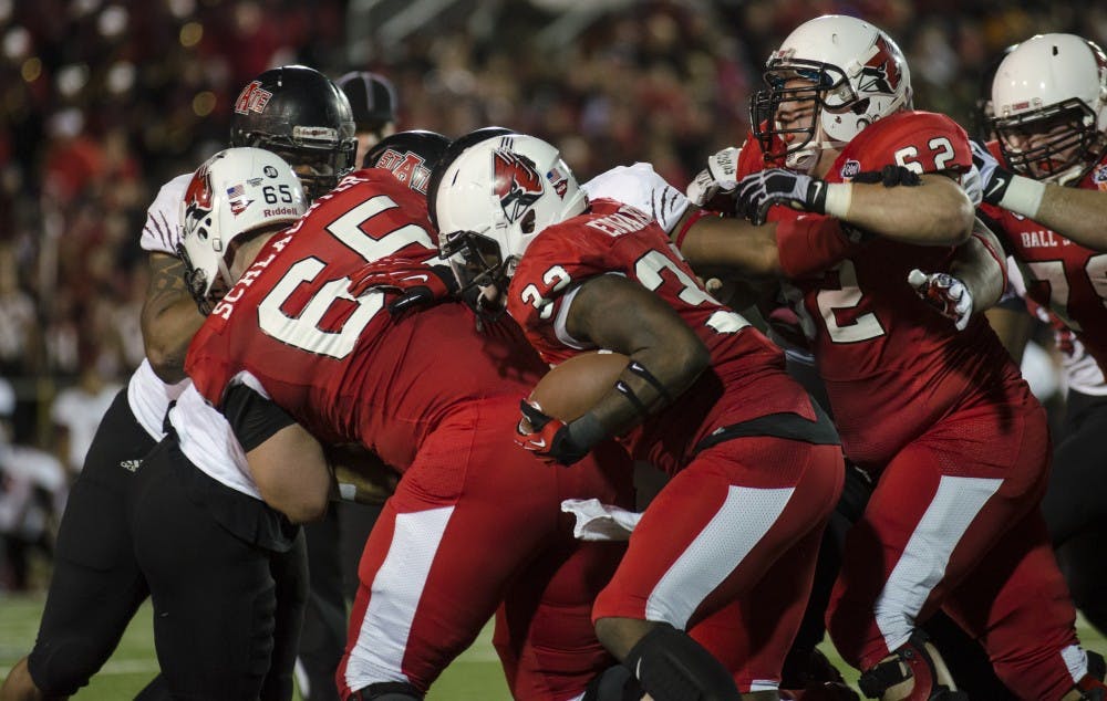 The team attempts to help move Jawahn Edwards across the line at the Go Daddy Bowl Game in Mobile, Ala. on Jan 5. Ball State was tied with Arkansas State moving into the half with a score of 10 - 10. DN PHOTO COREY OHLENKAMP