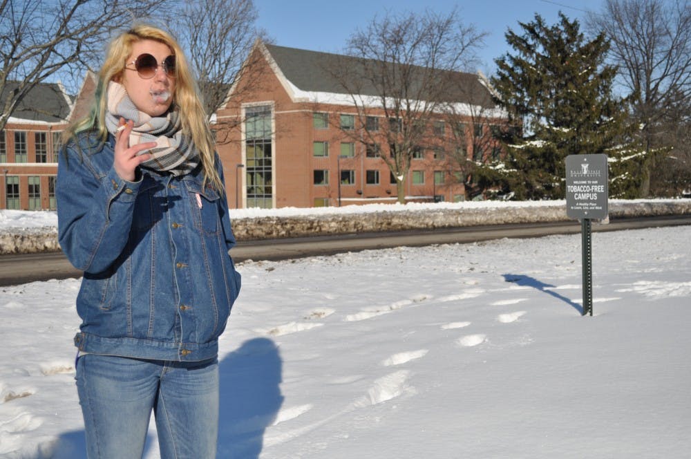Cassie Gabriel, a freshman elementary education and special education major, smokes a cigarette on the corner of Riverside Avenue and Dill Street.  DN FILE PHOTO ASHLEY DOWNING