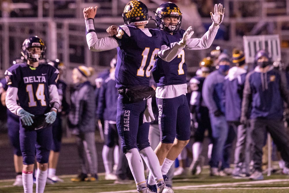 <p>Delta senior quarterback Brady Hunt celebrated with Delta junior running back Parker Faletic in the third quarter against Wayne High School Oct. 30, 2020, at Delta High School. The Eagles beat the Generals 49-18. Jacob Musselman, DN</p>