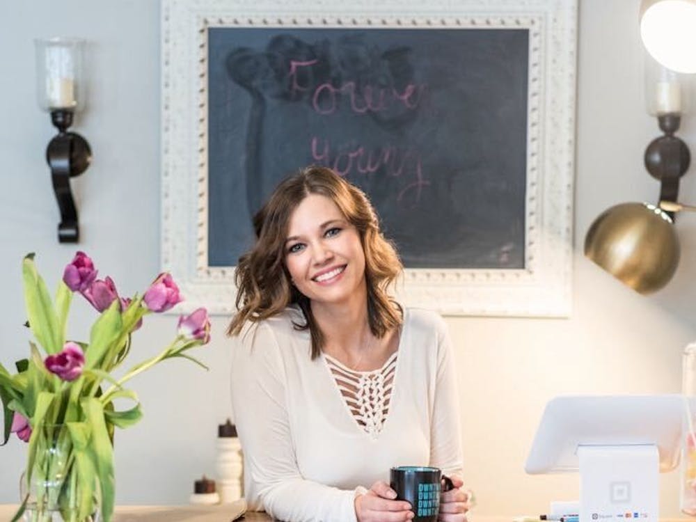 Amanda Hughes, owner of Forever Young, poses at her checkout desk. Hughes had five years of retail experience prior to opening her own boutique. Kishel Photography, Photo Courtesy