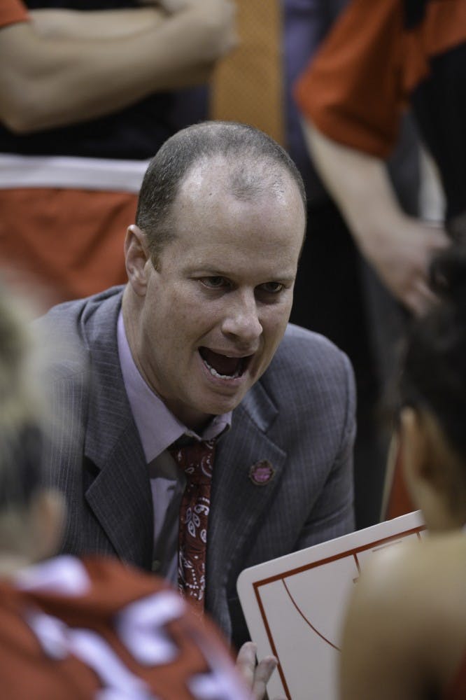 Head coach Brady Sallee talks to the women