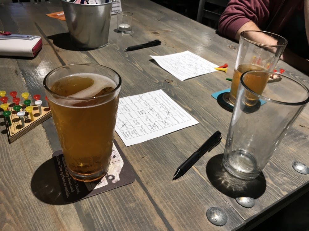 A bingo winner enjoys their pint from Ryan Remington. Remington is the creator and bar tender during "Music Bingo." Trevor Weldy,DN