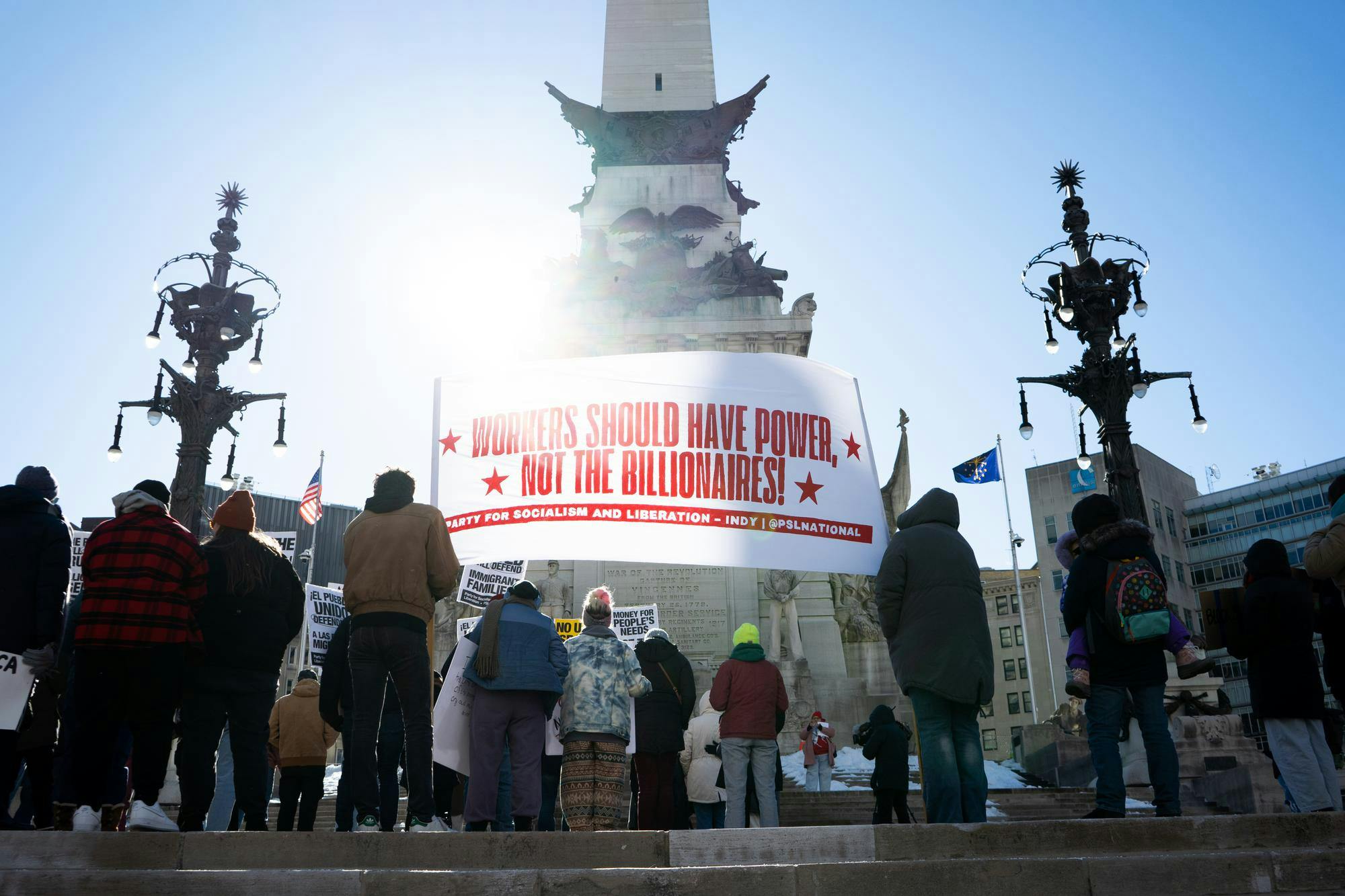 Protesters hold banners and signs while listening to speakers Jan. 20 at Monument Circle. Isabella Kemper, DN