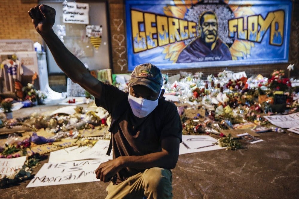 Protesters gather at a memorial for George Floyd where he died outside Cup Foods on East 38th Street and Chicago Avenue, June 1, 2020, in Minneapolis. Protests continued following the death of Floyd, who died after being restrained by Minneapolis police officers on May 25. (AP Photo/John Minchillo)