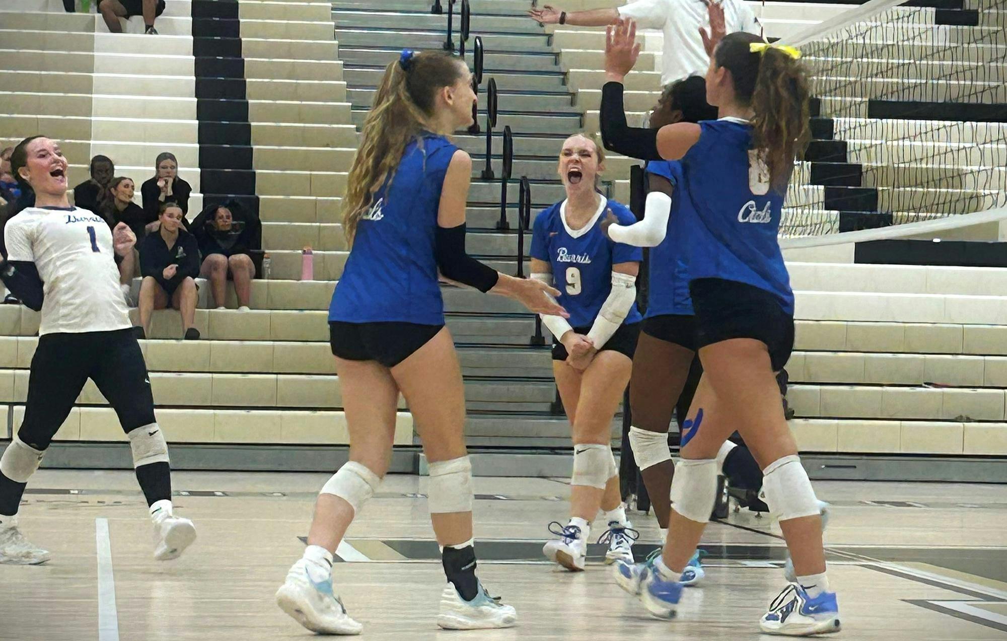 Muncie Burris players celebrate with each other after a play. Burris won the match 3-1. PHOTO BY BREANNE BUTLER