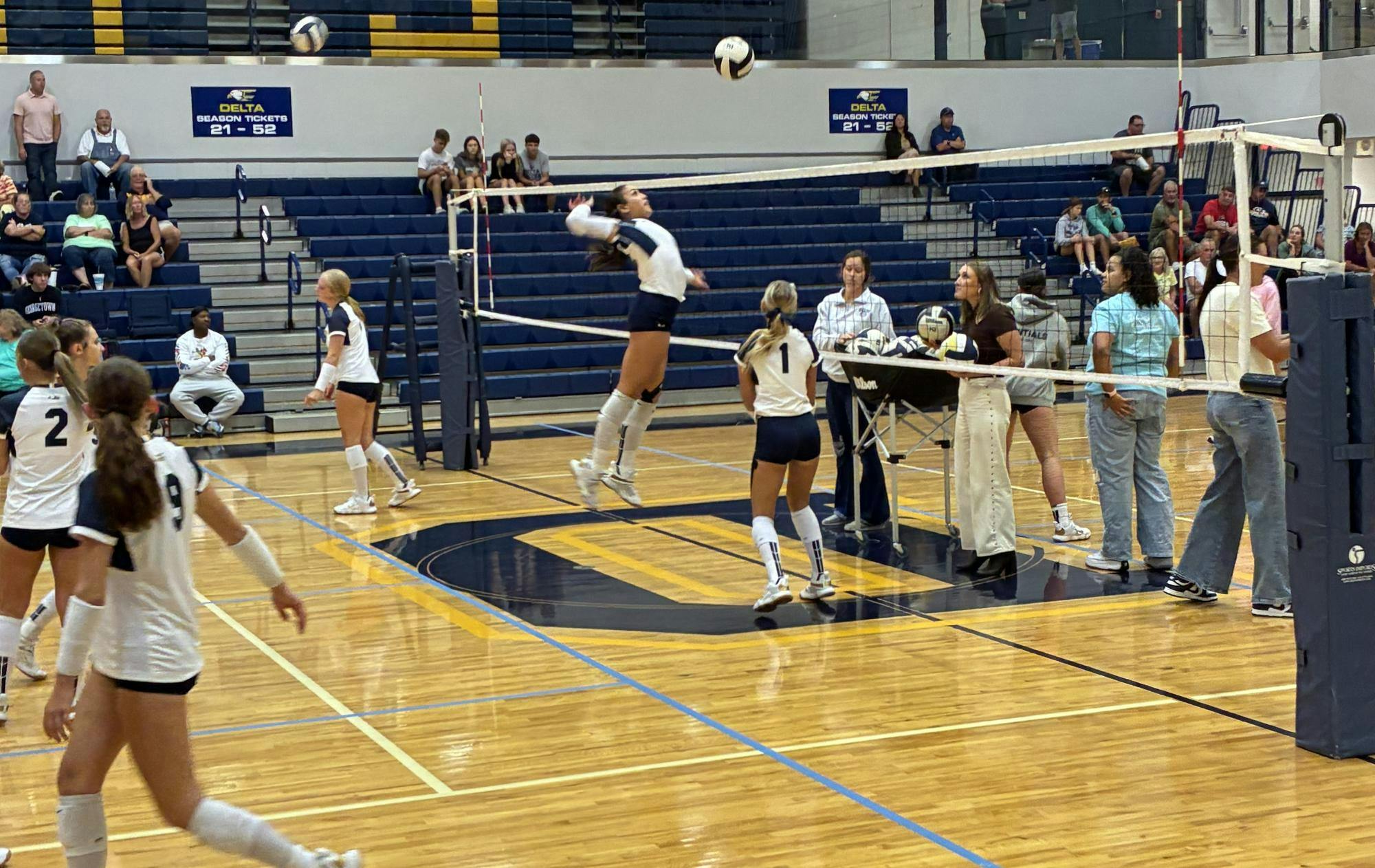 Kyra Murry (#10) jumps to spike the ball during pregame warmups. Murry warmed up aggressively before the match against New Palestine, foreshadowing her 12-kill performance.
