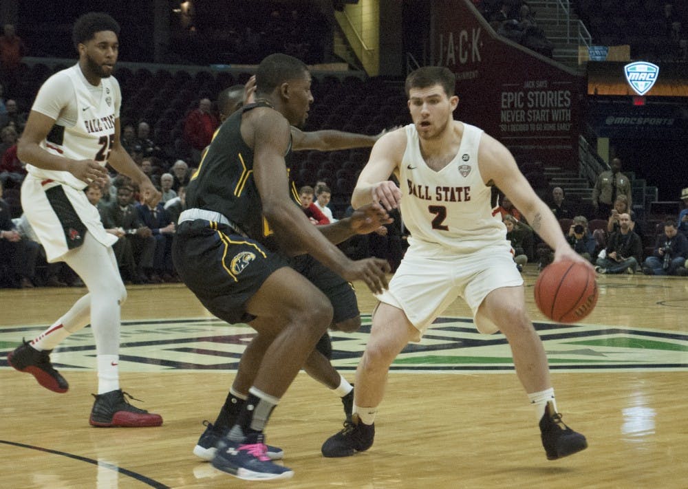 <p>Tayler Persons dribbles past a Kent State defender during the Mid-American Conference Tournament quarterfinals. <strong>Robby General, DN</strong></p>