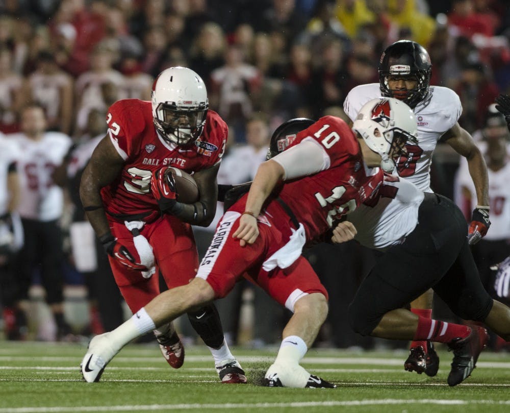 Jawhan Edwards dodges Arkansas defenders at the Go Daddy Bowl Game in Mobile, Ala. on Jan 5. Ball State was tied with Arkansas State moving into the half with a score of 10 - 10. DN PHOTO COREY OHLENKAMP