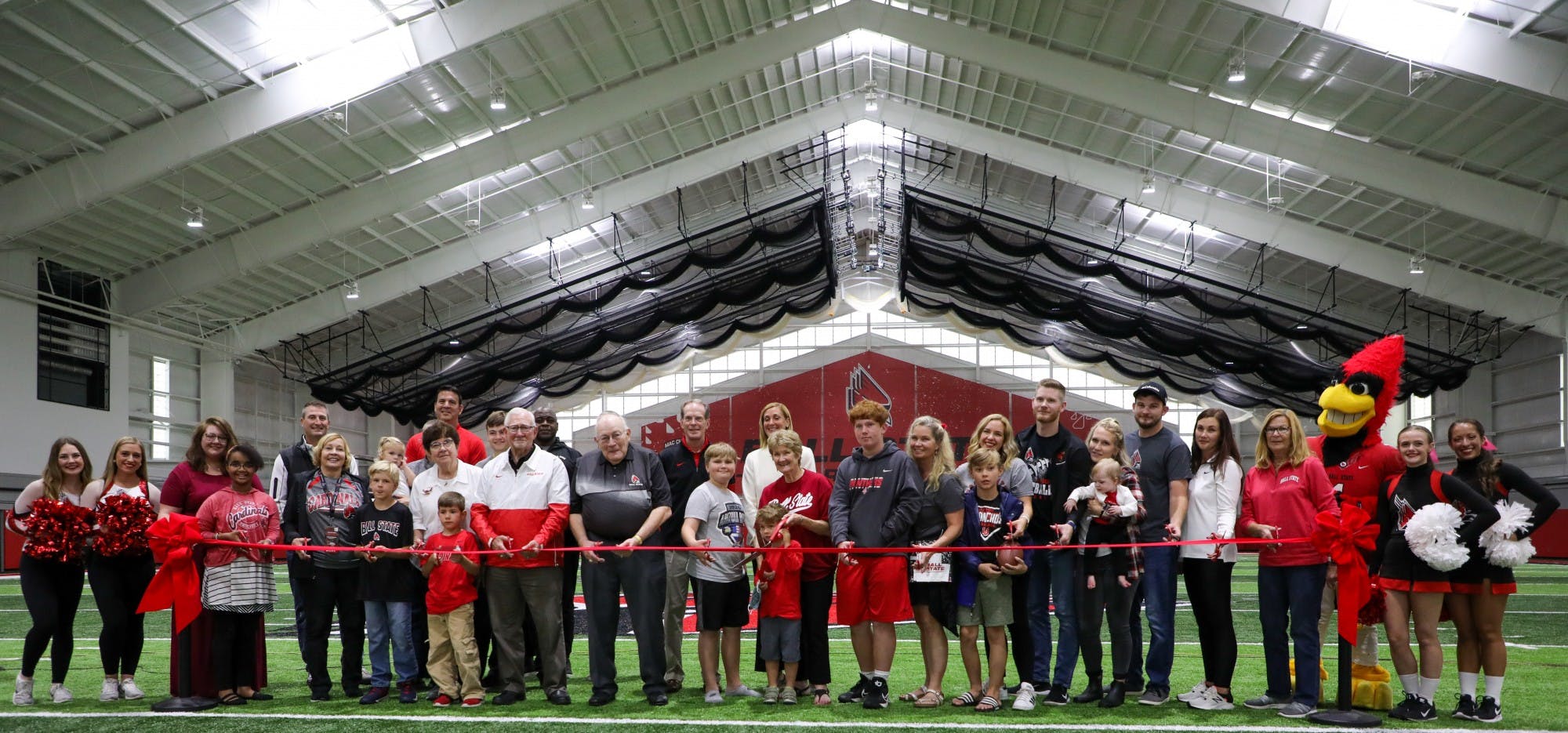 The Scheumann family, President Geoffrey Mearns, Beth Goetz and members of the Ball State community gathered to cut the ribbon at the Scheumann Family Indoor Practice Facility ribbon-cutting ceremony Saturday, October 2nd. Mearns said Scheumann embodied Ball State in all areas of his life. Daniel Kehn, DN