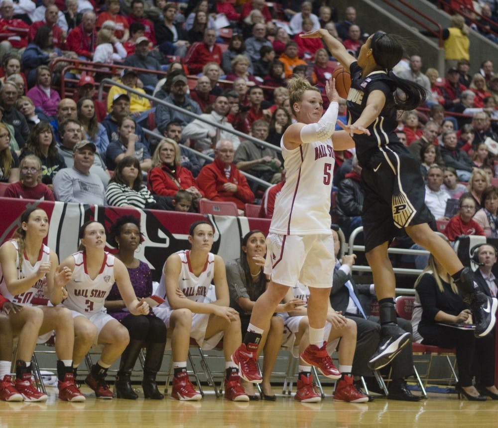 Sophomore guard Jill Morrison attempts a shot from behind the arc while Purdue player Ashely Morrissette attempts to block her during the game against Purdue on Nov. 14 at Worthen Arena. DN PHOTO BREANNA DAUGHERTY