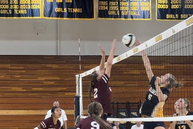 Sophomore Aubrey Antrim goes up for a crucial block to give her team back the momentum. PHOTO BY XAVIER HARRIS
