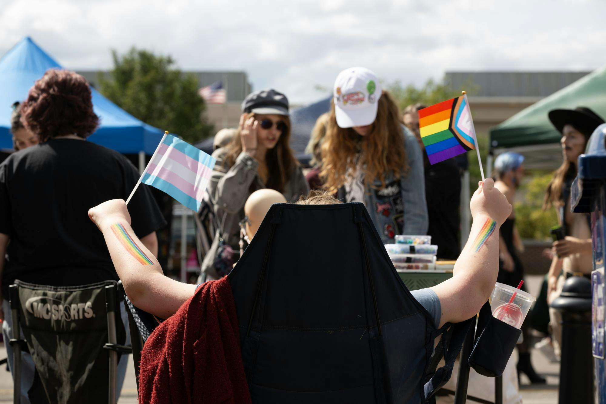 Vendors at Muncie Pride waving transgender and progress rainbow flags. Sep. 6 Muncie Indiana. Kyle Ingermann DN.