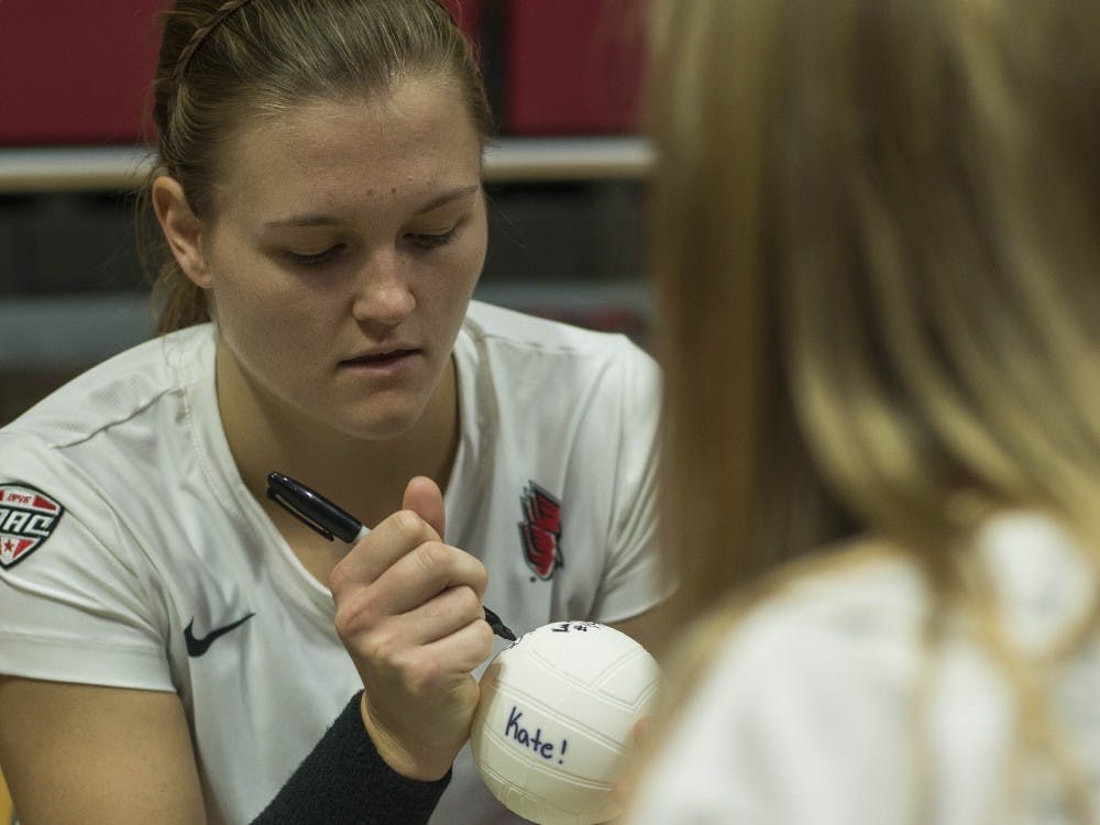 Senior opposite Jessica Lindsey signs a mini volleyball for for a fan after winning the game against Bowling Green on Oct. 20 at John E. Worthen Arena. Breanna Daugherty, DN