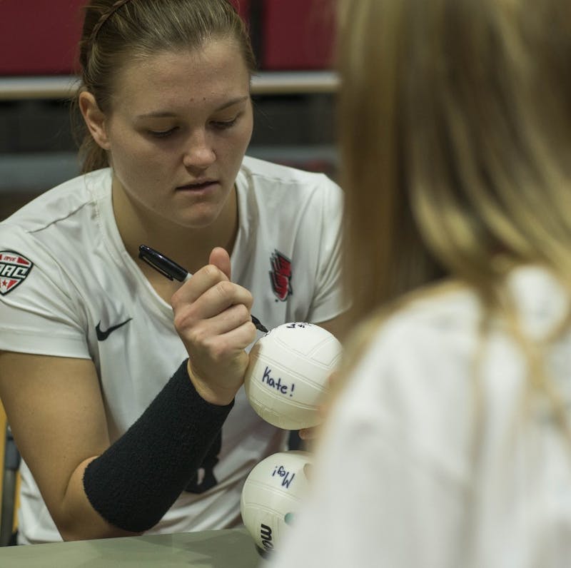 Senior opposite Jessica Lindsey signs a mini volleyball for for a fan after winning the game against Bowling Green on Oct. 20 at John E. Worthen Arena. Breanna Daugherty, DN