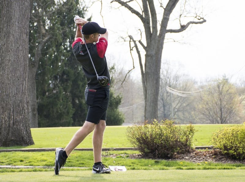 Junior Michael VanDeventer swings at the ball at hole 1 during the Earl Yestingsmeier Memorial Tournament at the Delaware Country Club on April 15. VanDeventer finished tied for first individually with a 2-under-par 208. Kaiti Sullivan // DN