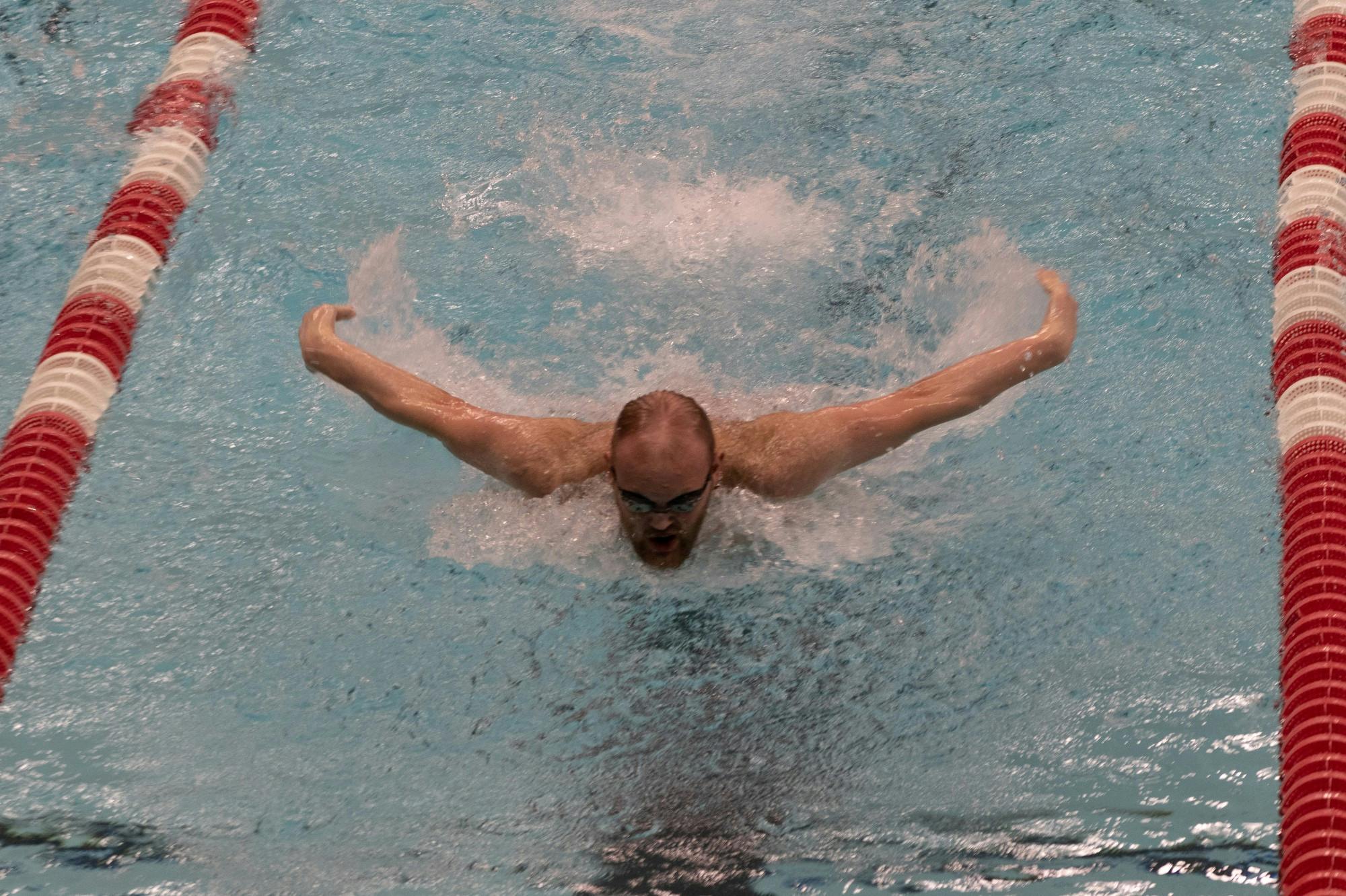 Freshman Jackson Ketcham fly swims Feb. 20, 2021, at Lewellen Aquatic Center. The Cardinals beat the Southern Illinois Sallikis 180-108. Madelyn Guinn, DN