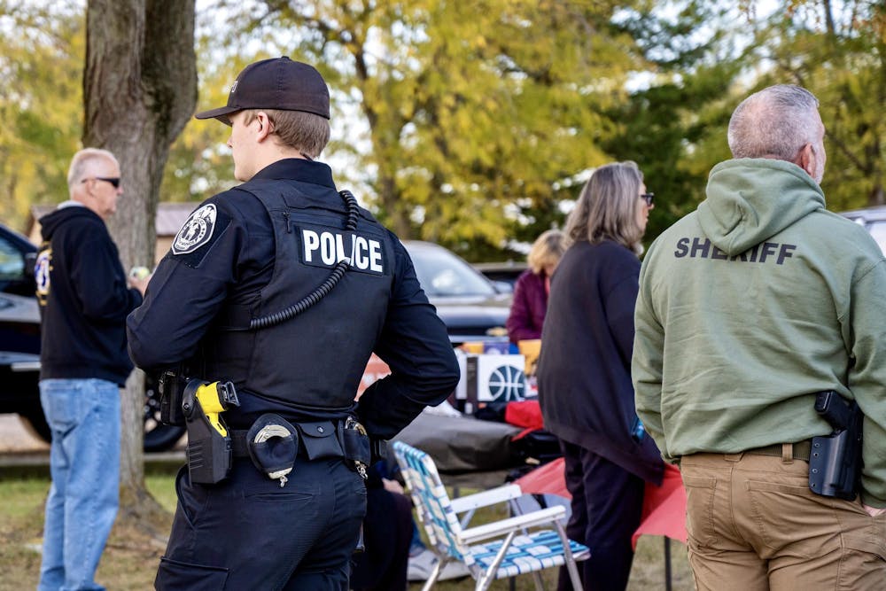 <p>A Muncie police officer and sheriff mingle with community members at Muncie’s Southside Neighborhood Association basketball and kickball event.</p><p><br></p>