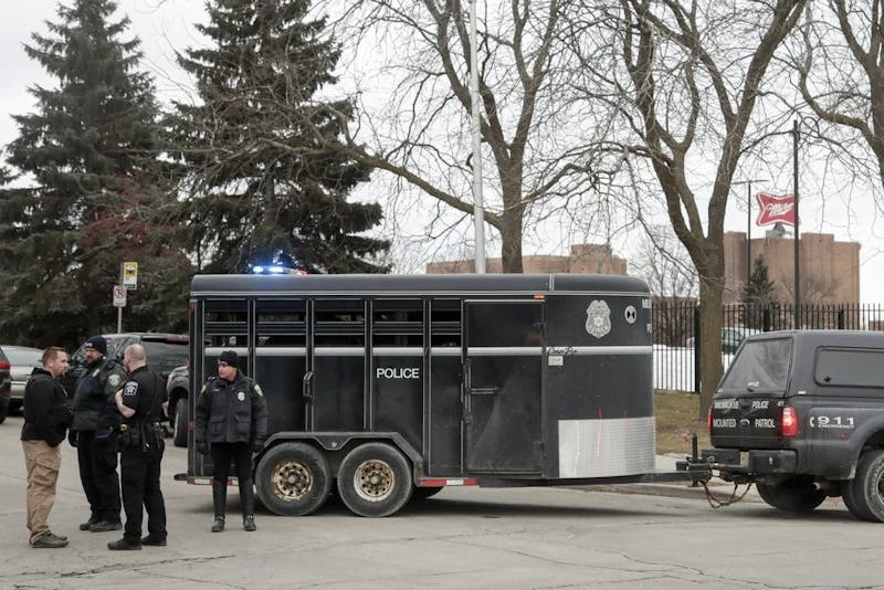 Police work outside the Molson Coors Brewing Co. campus in Milwaukee on Wednesday, Feb. 26, 2020, after reports of a possible shooting. (AP Photo/Morry Gash)