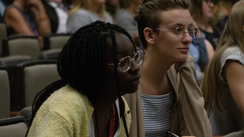 Cultural anthropology major Divine Ngangu (left) and freshman biology/pre-med major Eilish Kelly (right) look on as Adam Schwartz, professor language, culture and society a Oregon State University, speaks Thursday in room 175 in the Art and Journalism Building. Schwartz screened the film “Accidental Courtesy: Daryl Davis, Race &amp; America” and hosted a talk at the event. John Lynch, DN