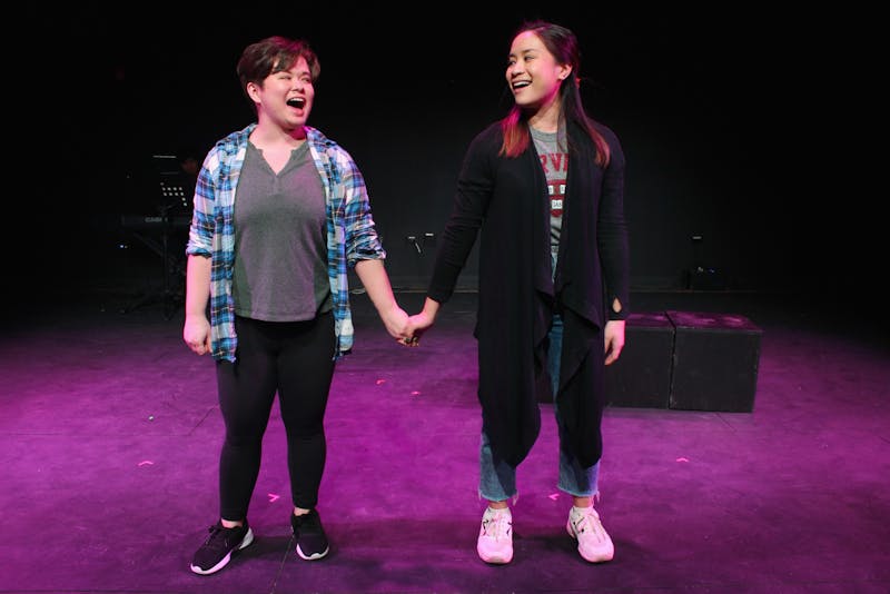 2019 Ball State alumna Devon Hayakawa (left) holds hands with Janelle Villas (right) as they perform in "Baked! The Musical" at Chicago Musical Theatre Festival. "Baked! The Musical" featured an all Asian American cast, and the musical's writers drew from their experiences as children of immigrants in the U.S.  Underscore Theatre Company, Photo Courtesy