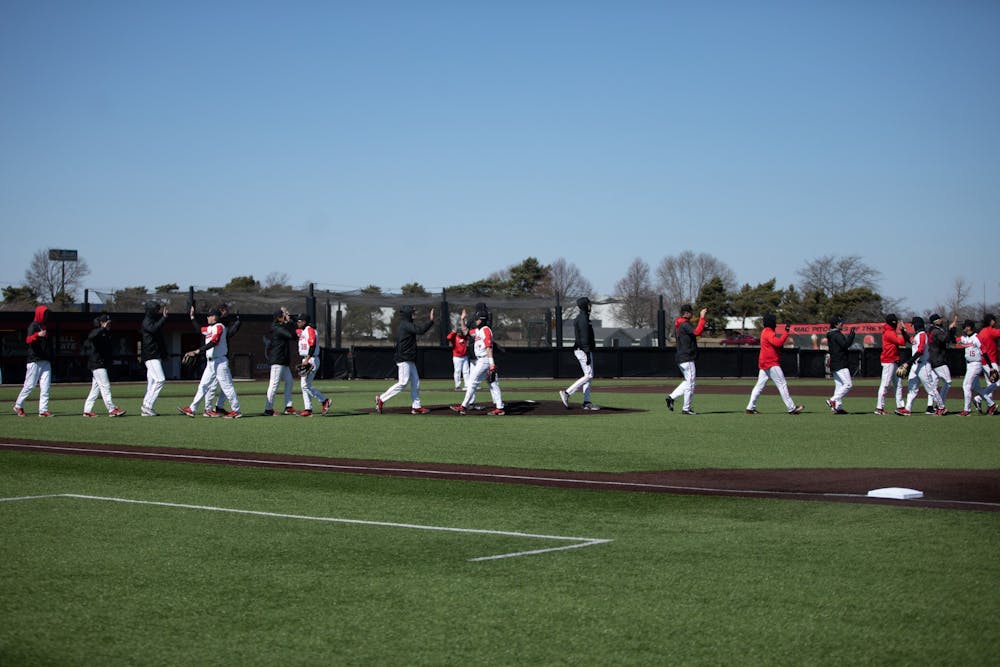 Ball State baseball players celebrate their win in the first game of the double header against Eastern Michigan Mar. 13 at First Merchants Ballpark Complex. The Cardinals opened their Mid-American Conference season going winning both games against Eastern Michigan with scores of 2-1 and 6-4. Eli Houser, DN