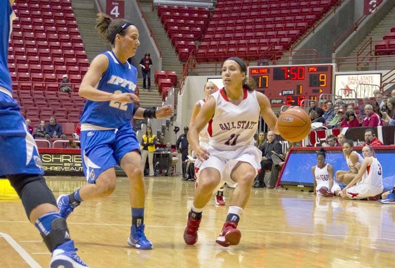 Junior Brandy Woody attempts to find an opening in the IPFW defense including Mur Hagerman during the first half of the game on Nov. 19, 2012. Woody has scored nearly double her points from her previous season. DN FILE PHOTO EMMA FLYNN