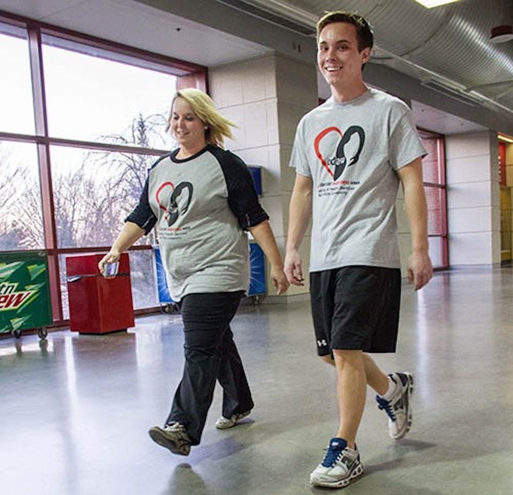 Jason Walls, a masters student in counseling psychology, and Kodee Walls, a counseling psychology doctoral student, walk together in the “Everybody Get Moving: Walk to Raise Awareness for Eating Disorders” Sunday in Worthen Arena. Other events will be hosted this week by the Counseling and Health centers such as “Everybody’s Different: Panel Discussion about Body Image and Diversity,” “Healthy Eating for Everybody: How to Navigate Dining Out,” and “Mirror Mirror on the Wall: How Media Messages affect Everybody.” There are also eating disorder screenings every Sunday through Thursday at the Student Center lobby or at the Student Recreation center. DN PHOTO EMMA FLYNN