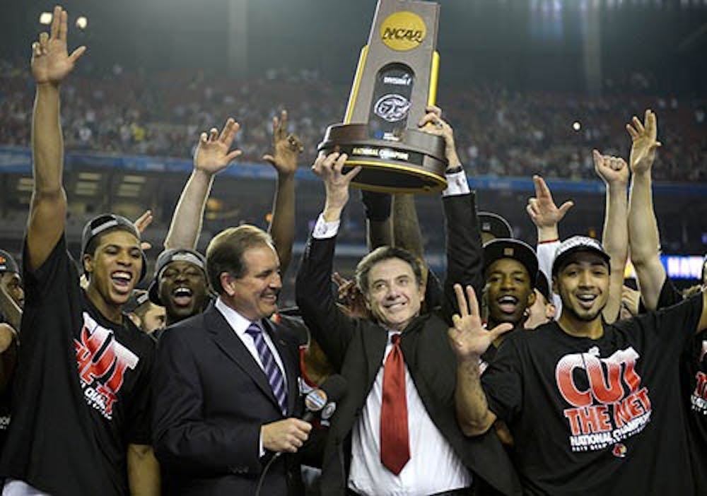 Louisville Cardinals head coach Rick Pitino celebrates with his team after defeating Michigan, 82-76, and winning the NCAA Men's Basketball Championship at the Georgia Dome in Atlanta, Georgia, Monday. MCT PHOTO