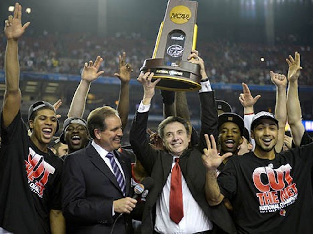 Louisville Cardinals head coach Rick Pitino celebrates with his team after defeating Michigan, 82-76, and winning the NCAA Men's Basketball Championship at the Georgia Dome in Atlanta, Georgia, Monday. MCT PHOTO