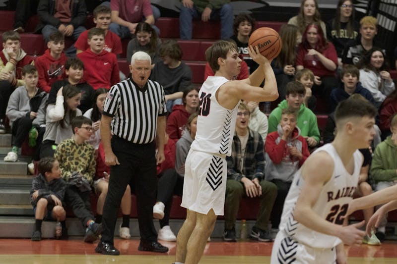 Wapahani junior Isaac Andrews attempts a three-point shot Feb. 2 at Wapahani High School. Andrews finished with seven made three-pointers and 27 points. Zach Carter, DN