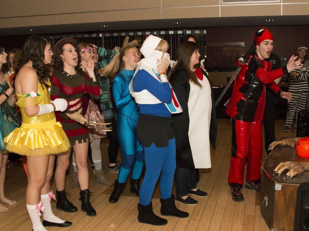 Keegan Browne reacts to winning the award for original costume during the Elliott Hall Halloween Ball. The judges said they liked his Spiderman costume, but Browne responded that he was dressed as Deadpool