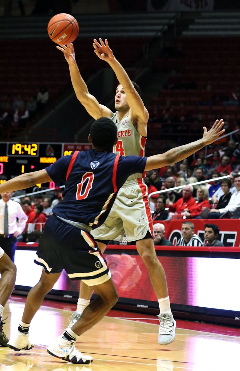 Ball State senior forward Kyle Mallers passes the ball over Howard freshman guard Khalil Robinson during the Cardinals' game against the Bison Saturday, Nov. 23, 2019 at John E. Worthen Arena, Muncie, Ind. Mallers tied the program record with eight three pointers. Paige Grider, DN