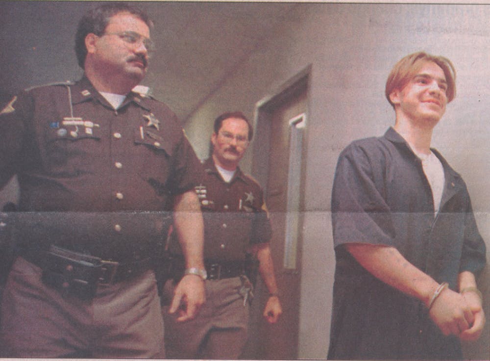 In Delaware County Superior Court 1, 18-year-old Larry Newton pleaded guilty to the September 1994 murder of sophomore Christopher Coyle near campus on Neely Avenue. Muncie Police Capt. Richard Pickett and officer David W. Hanauer escort Newton back to prison after his guilty plea hearing. Cindee Nolley, DN File&nbsp;