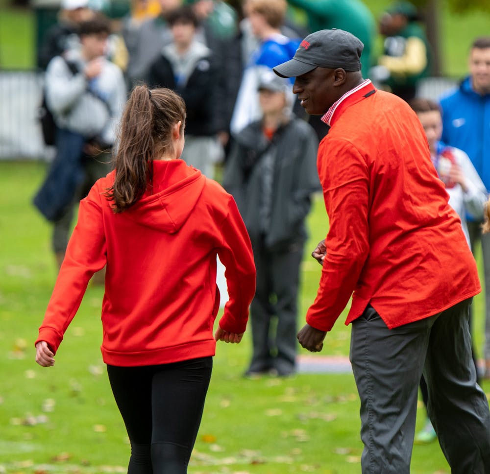 <p>Head Coach Adrian Wheatly coaches one of the cross country runners Oct. 30, 2021 at the MAC Championship in Ypsilanti, Mich. Ball State Athletics, Photo Provided</p>
