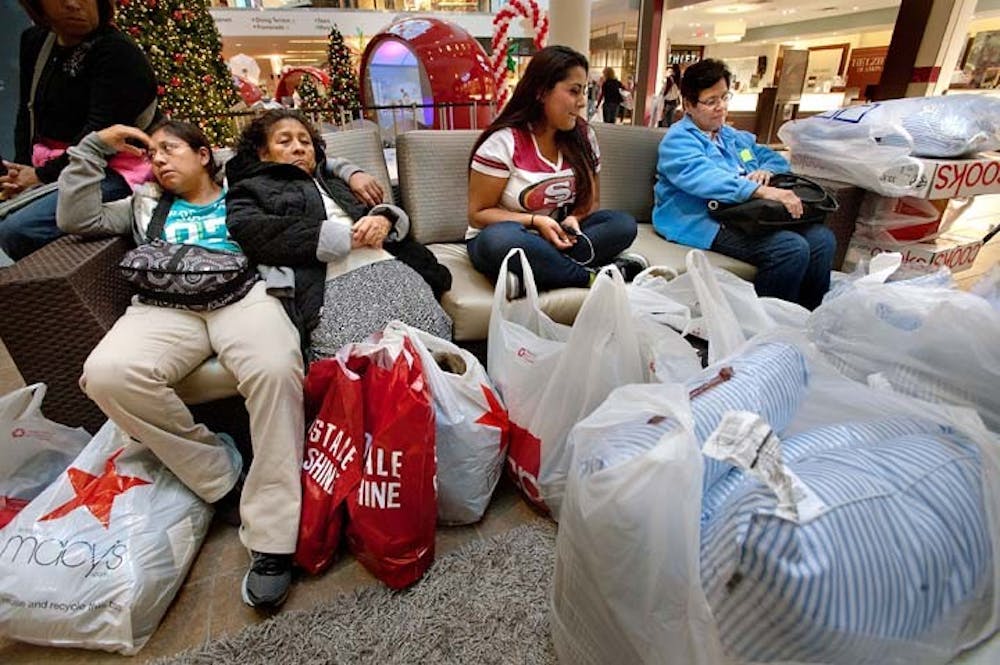 Sofia Segovia, left, and Inocencia Segovie of Lincoln, Calif., Sheryl Sharma and Mary Wagner rest with their shopping bags Friday at the Westfield Galleria in Roseville, Calif. They had been Black Friday shopping since 5 a.m. MCT PHOTO