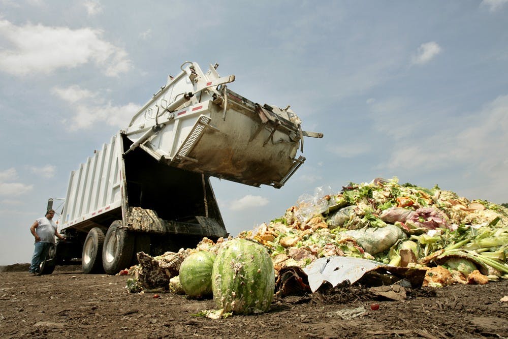 Driver Aaron Cornine lowers the back of the truck after dumping his load of food and compostable waste at Missouri Organic's Liberty facility, July 9, 2009. Much of it is covered in dough from baked goods. (Jill Toyoshiba/Kansas City Star/MCT)
