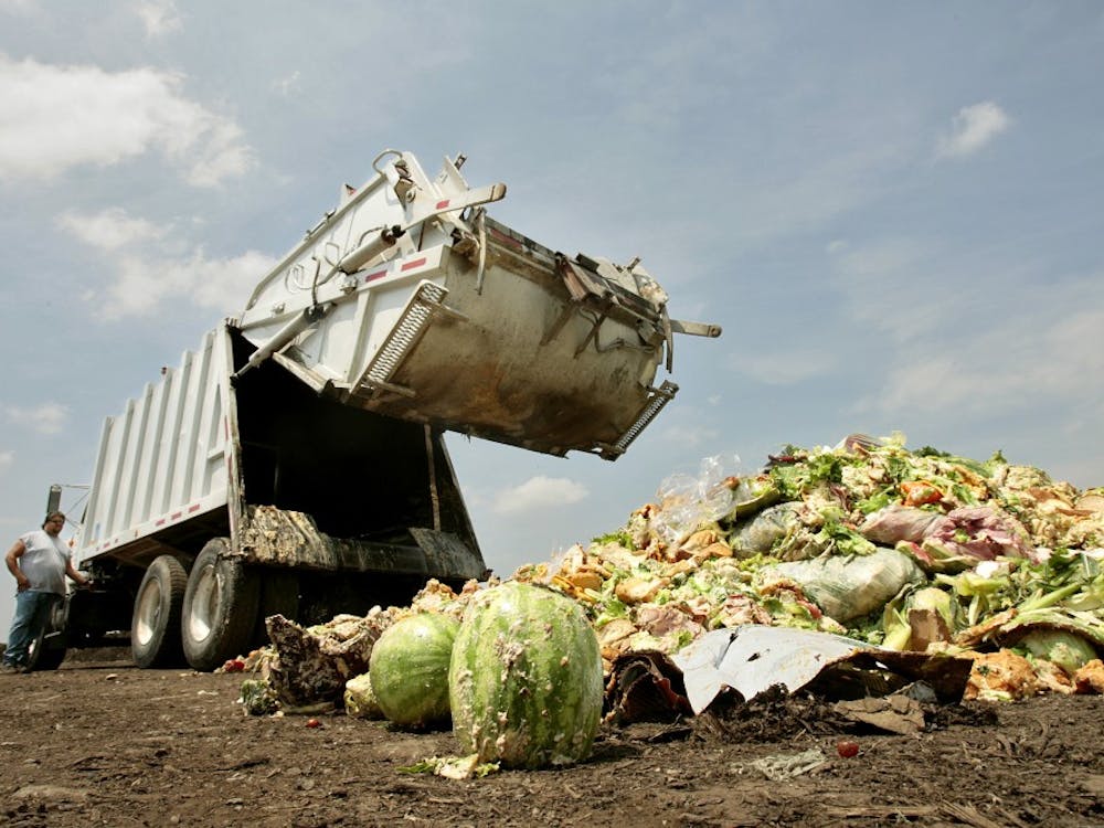 Driver Aaron Cornine lowers the back of the truck after dumping his load of food and compostable waste at Missouri Organic's Liberty facility, July 9, 2009. Much of it is covered in dough from baked goods. (Jill Toyoshiba/Kansas City Star/MCT)