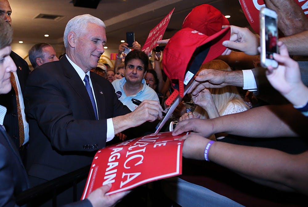 Republican vice president candidate Mike Pence signs banners and greets supporters during a campaign rally at Renaissance Ballroom in West Miami on Friday, Nov. 4, 2016. (Pedro Portal/El Nuevo Herald/TNS)