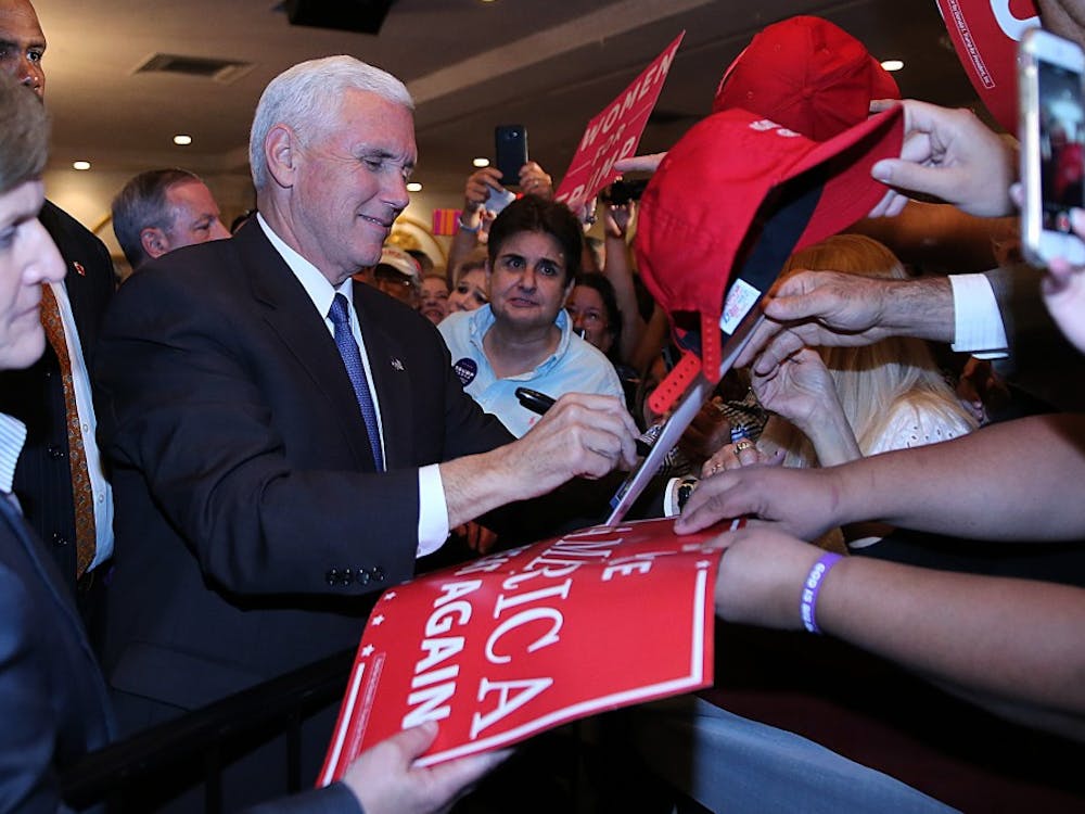Republican vice president candidate Mike Pence signs banners and greets supporters during a campaign rally at Renaissance Ballroom in West Miami on Friday, Nov. 4, 2016. (Pedro Portal/El Nuevo Herald/TNS)