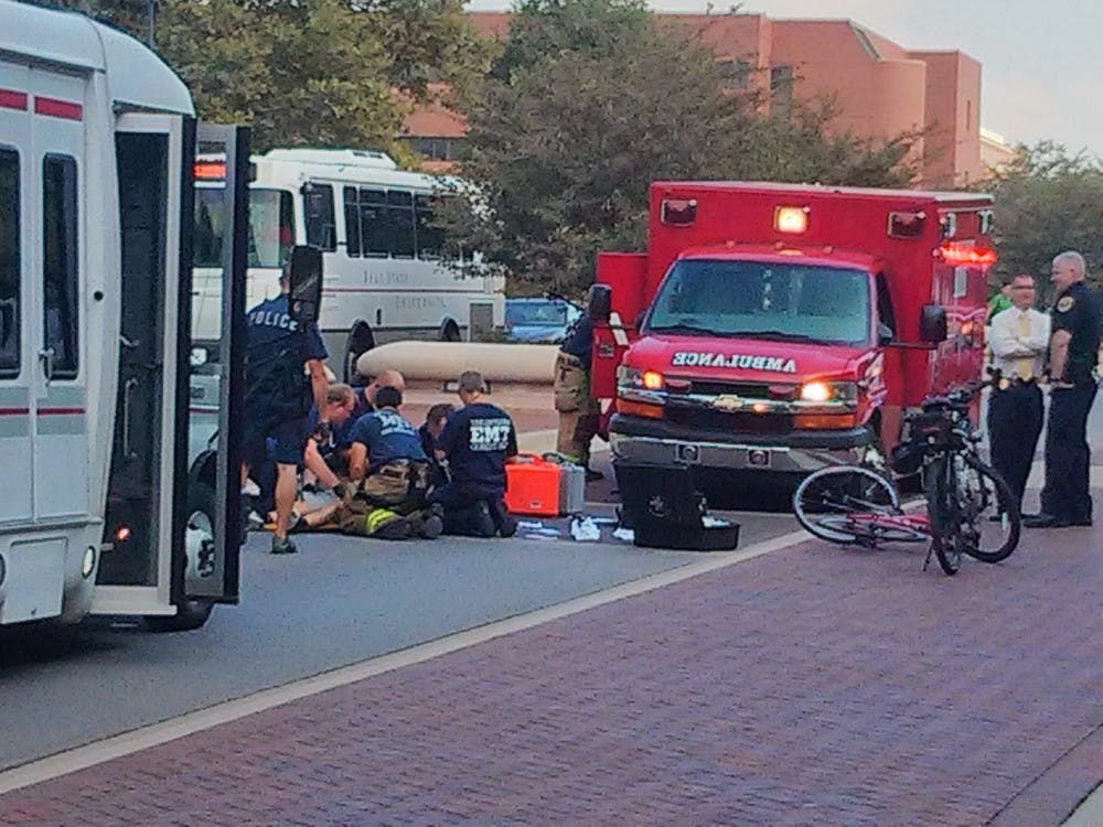 <p><strong>Emergency crews</strong> respond to call of a head injury after a man fell off his bike. A student witness said the chain on his red bike broke and his head hit the ground in the street around 10 a.m. Sept. 5 on McKinley Avenue. <em>PHOTO PROVIDED BY ERICA MOHLER</em></p>
