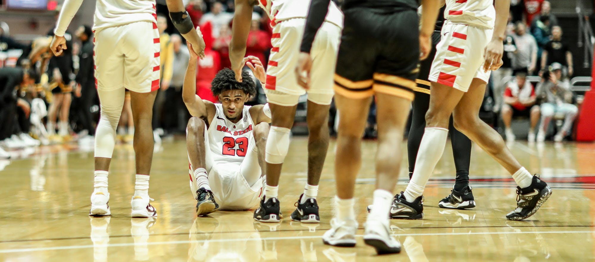 Junior guard Kaiyem Cleary gets picked up by teammates during a game against Toledo March 3 at Worthen Arena. Cleary scored five points during the game. Katelyn Howell, DN