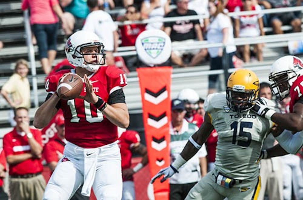 Senior quarterback Keith Wenning prepares to pass the ball down field Saturday at the game against the University of Toledo. Wenning is close to breaking the career record for passing yards, which is held by Nate Davis with 9,233 yards. DN FILE PHOTO JONATHAN MIKSANEK