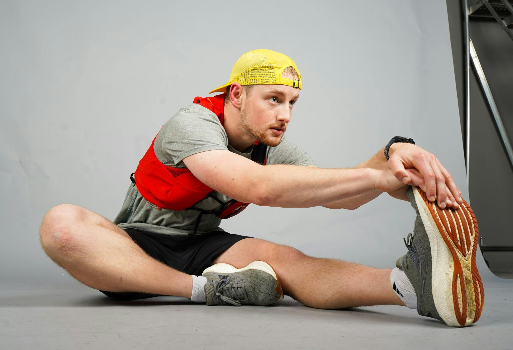 Ball State senior Isaac Rogers poses for a photo streching with his gear he uses during races Nov. 3 at Ball State University. Isabella Kemper, DN