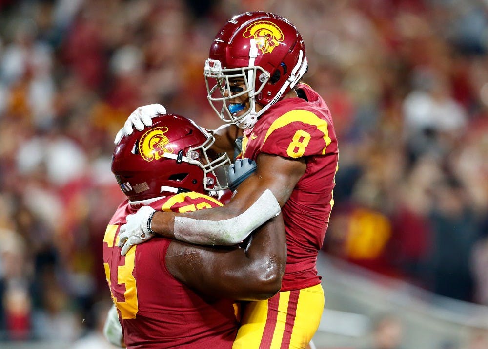 USC wide receiver Amon-Ra St. Brown (8) is congratulated by teammate Drew Richmond after scoring a touchdwon against Stanford in the second quarter at the Los Angeles Memorial Coliseum on Saturday, Sept. 7, 2019. (Luis Sinco/Los Angeles Times/TNS)