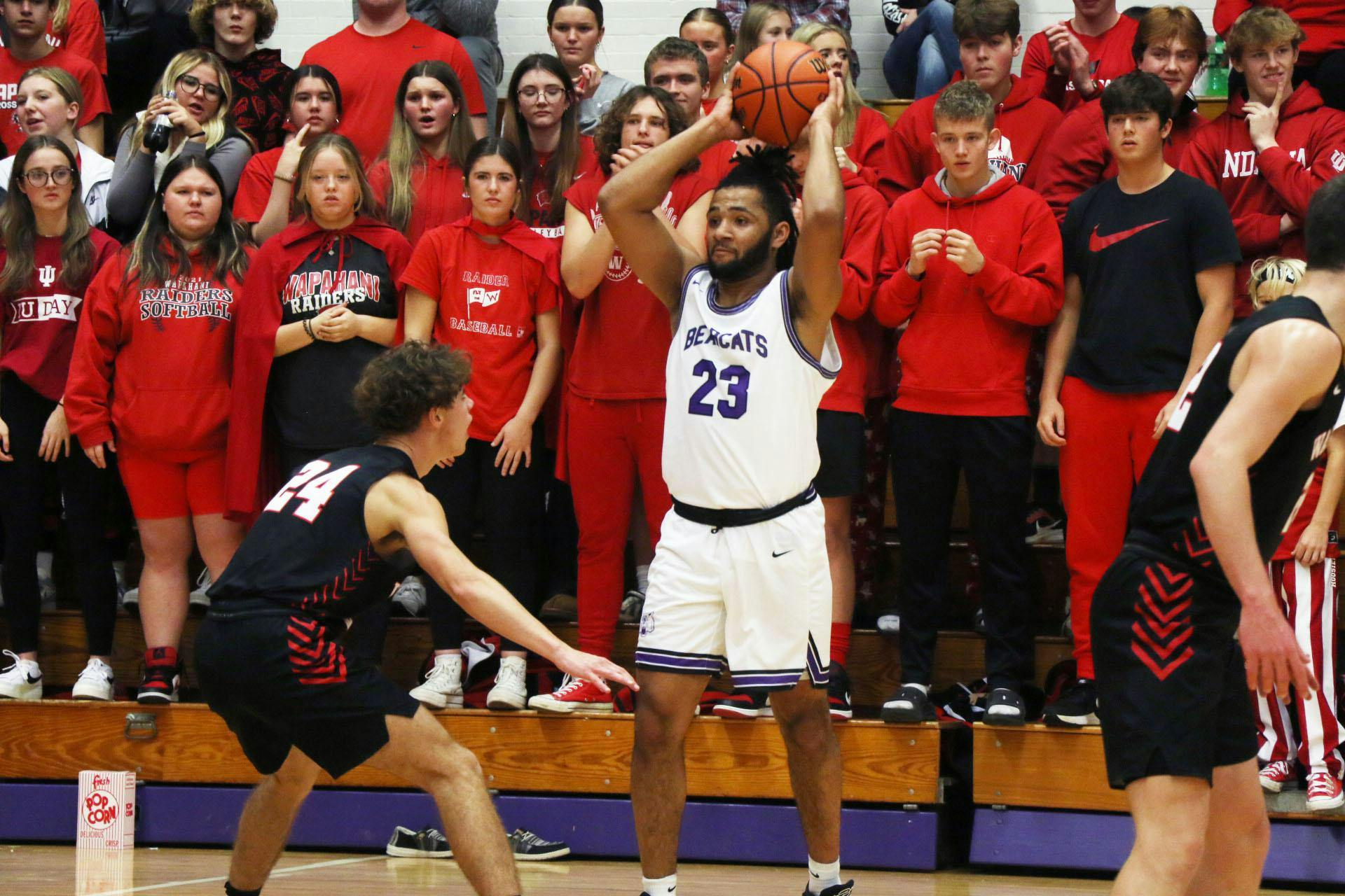 Muncie Central senior Xayden Douglas looks to pass Nov. 21 against Wapahani at the Muncie Central Fieldhouse. Zach Carter, DN.