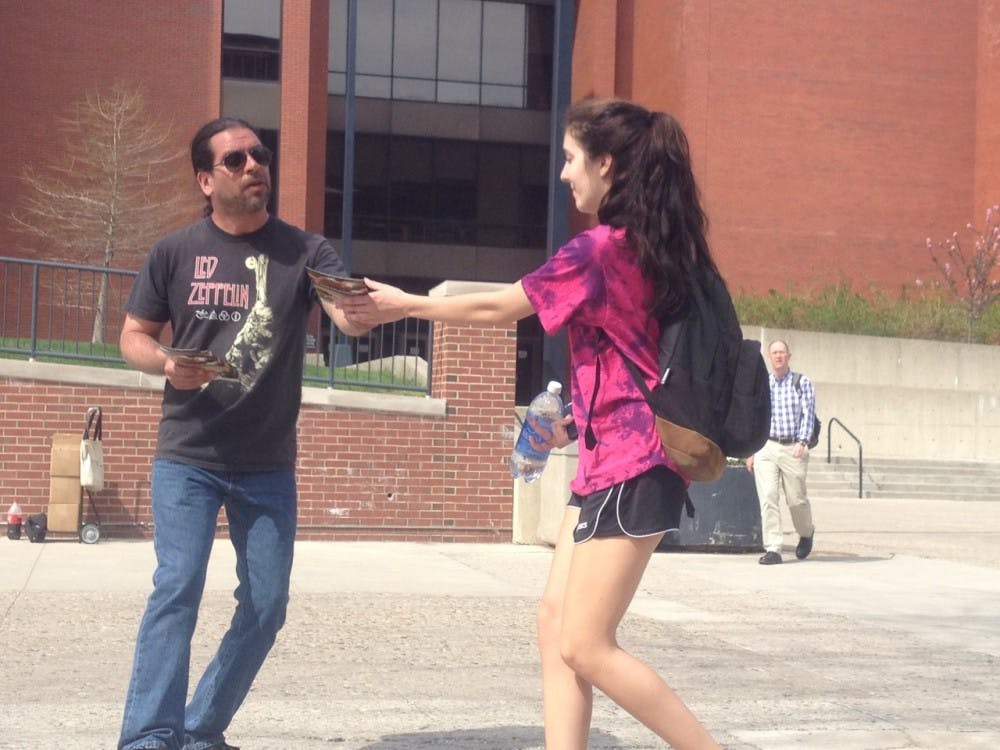 Joe Espinosa passes out flyers to students about reducing chicken consumption. Espinosa goes all across the midwest to raise awareness about animal consumption. DN PHOTO ALLIE KIRKMAN