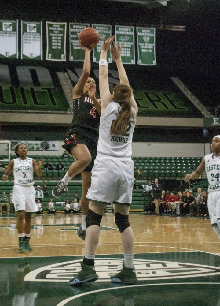 Senior guard Nathalie Fontaine shoots a floater over Eastern Michigan senior center Rachel Kehoe. Fontaine is now just 22 points shy of Tamara Bowie’s career scoring record of 2,901 points. DN PHOTO COLIN GRYLLS