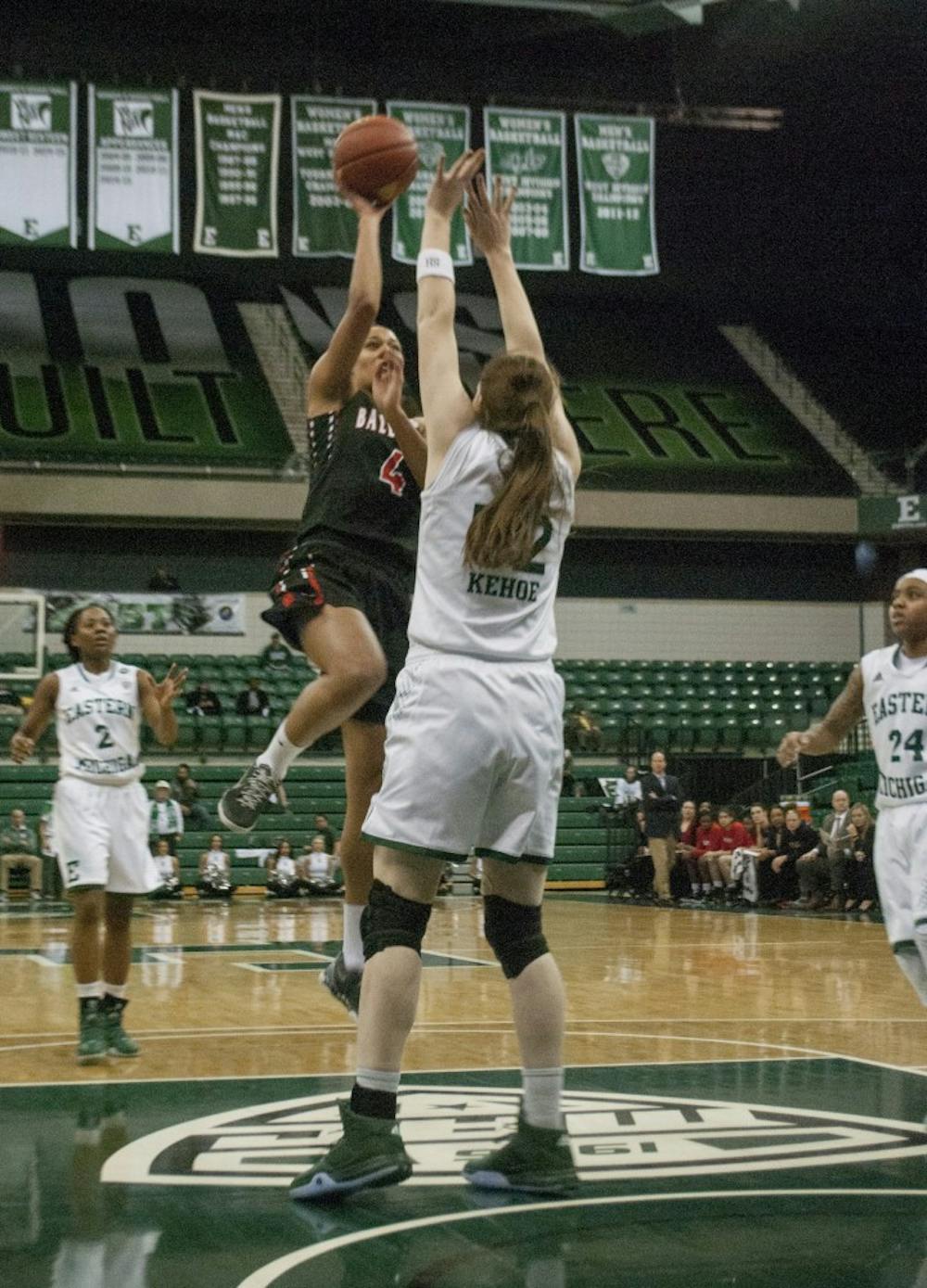 Senior guard Nathalie Fontaine shoots a floater over Eastern Michigan senior center Rachel Kehoe. Fontaine is now just 22 points shy of Tamara Bowie’s career scoring record of 2,901 points. DN PHOTO COLIN GRYLLS