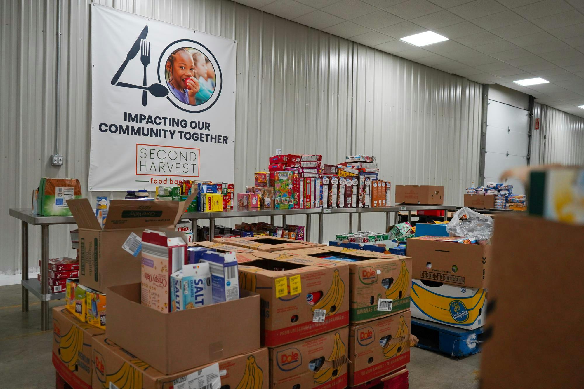 Second Harvest's volunteers set up for packing food Oct. 17 at Second Harvest Food Bank. Isabella Kemper, DN